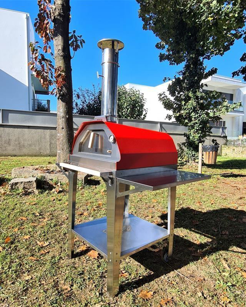 Picture of red Brasa pizza oven with trolley stand