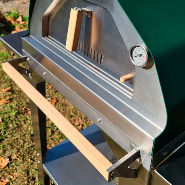 Picture of green Brasa pizza oven with trolley stand